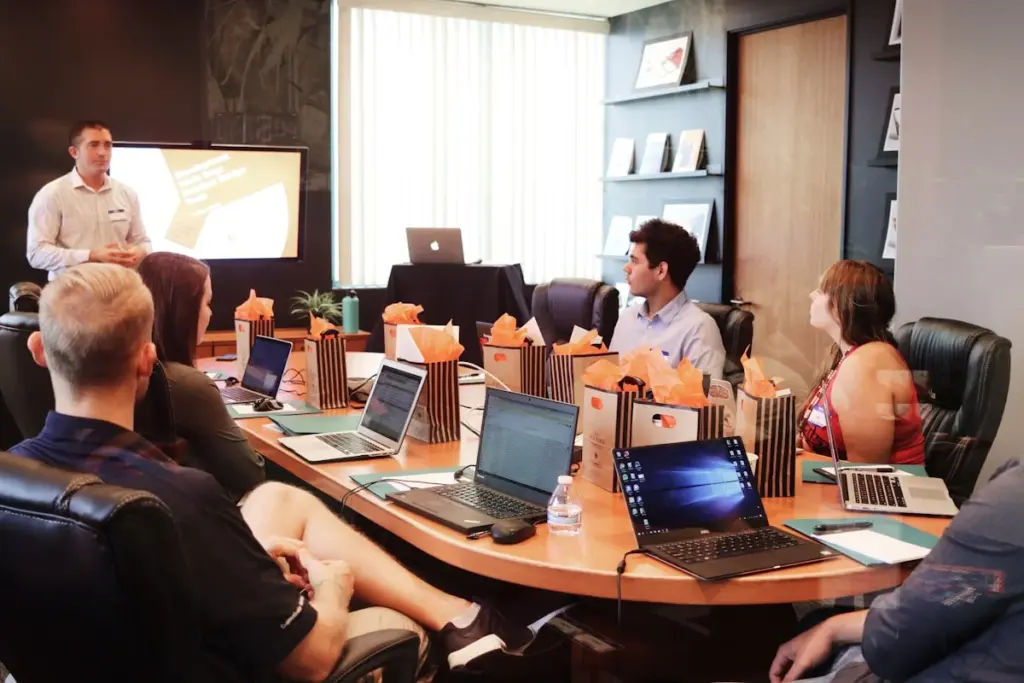 Office meeting room with people working at laptops